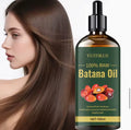 Nuvyra Batana Oil with model showing shiny hair